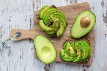 protein bread garnished with sliced avocado, cress and chili powder