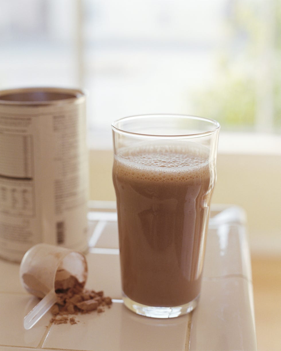 protein drink with can and measuring cup on counter