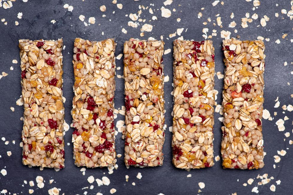 protein energy bar with wholegrain cereals and raspberry fruit on dark background isolated