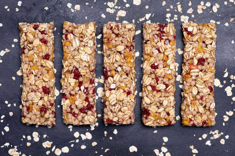 protein energy bar with wholegrain cereals and raspberry fruit on dark background isolated