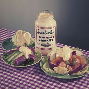 salad topped with mayonnaise with mayonnaise bottle, close up