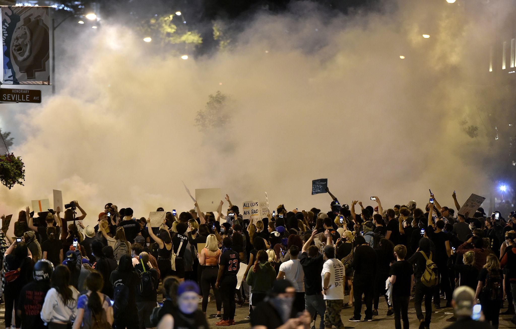 a large cloud of tear gas hovers over protesters gathered at wyandotte street and w 47th street thousands of people gathered saturday, may 30, 2020, at the country club plaza for a second night of protests against police brutality and the death of george floyd