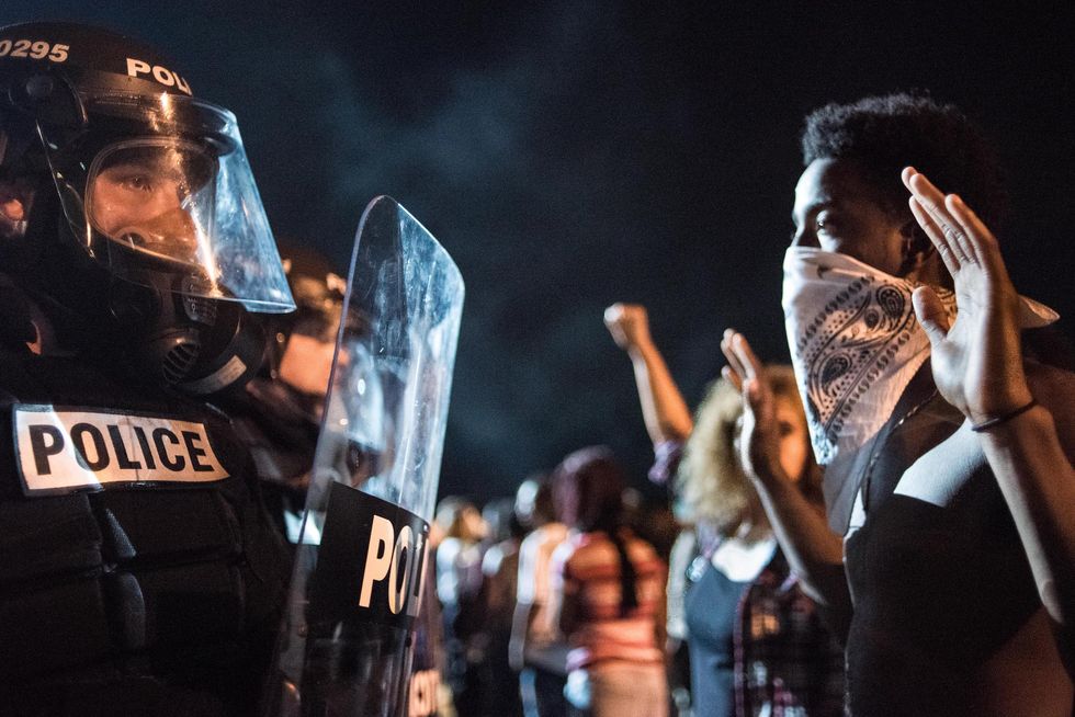 charlotte, nc   september 21 police officers face off with protesters on the i 85 interstate 85 during protests in the early hours of september 21, 2016 in charlotte, north carolina the protests began last night, following the fatal shooting of 43 year old keith lamont scott by a police officer at an apartment complex near unc charlotte photo by sean rayfordgetty images