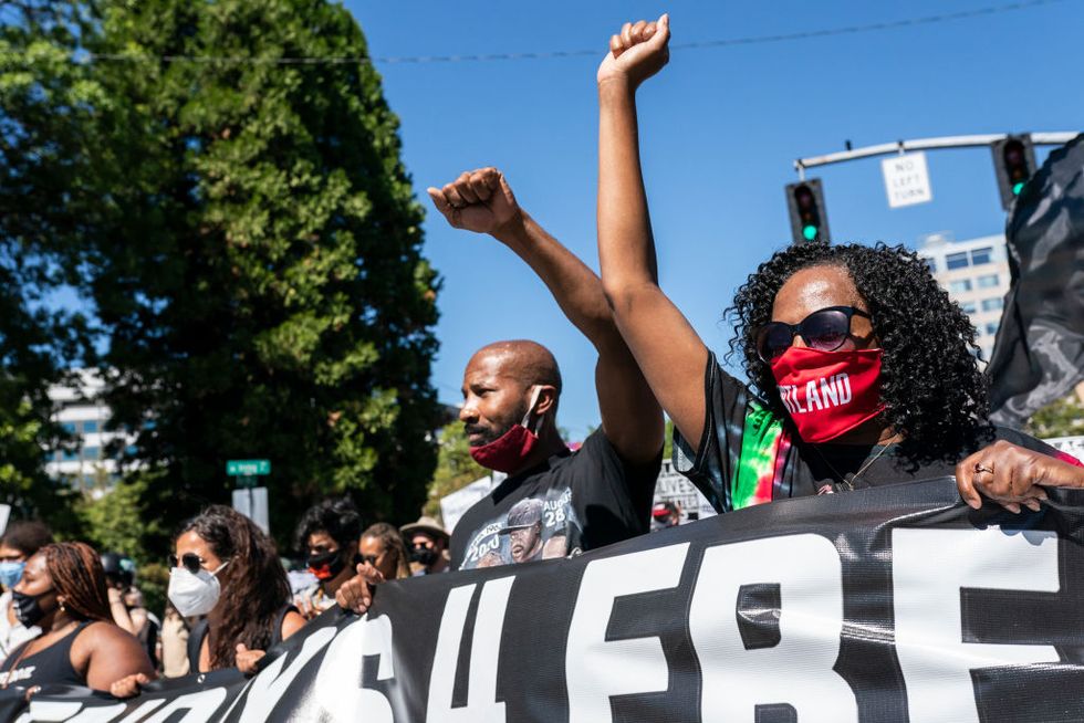 naacp organizes march in portland, oregon in solidarity with dc's marprotesters hold their fists in the air during a black lives matter march on august 28, 2020 in portland, oregonch on washington
