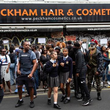 protesters post placards outside peckham hair and cosmetics