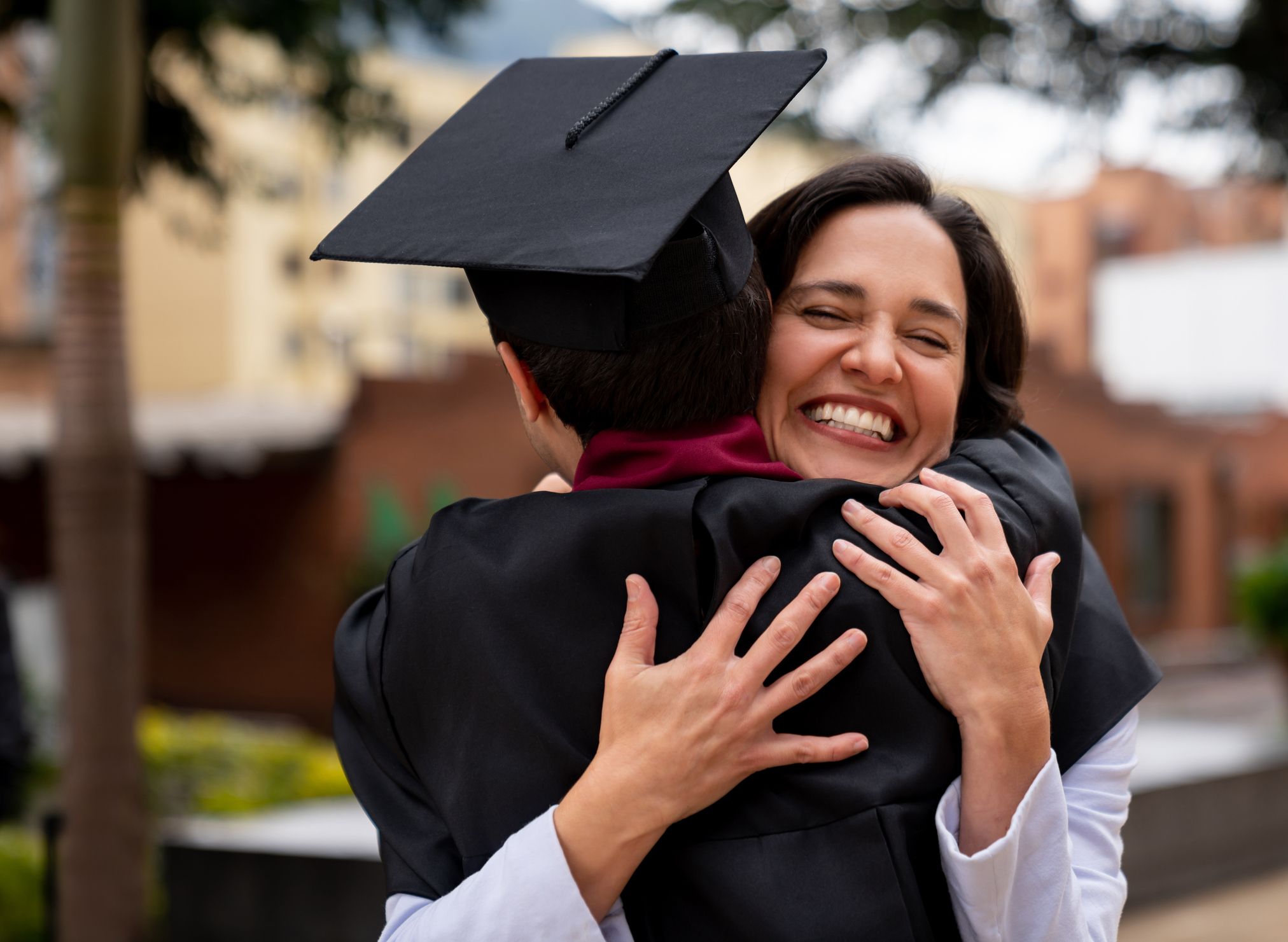 proud mother hugging her graduating son royalty free image 1647955950