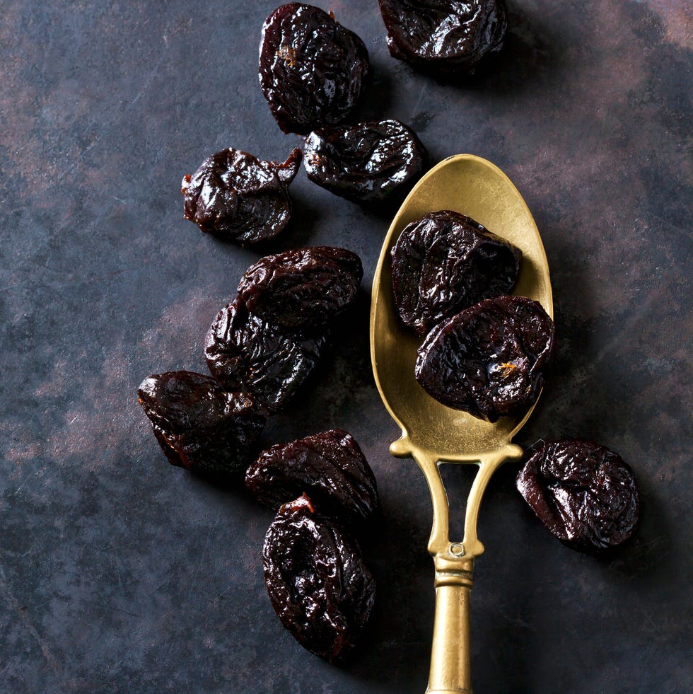 prunes on a vintage brass spoon