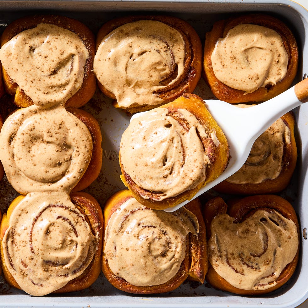 cinnamon rolls topped with a pumpkin spice cream cheese icing