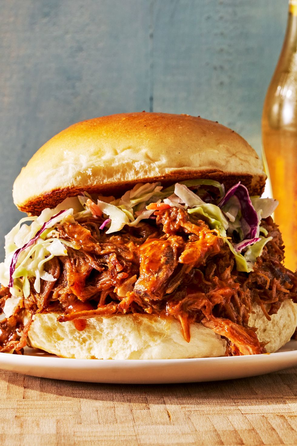 pulled pork sandwich on a bun topped with coleslaw