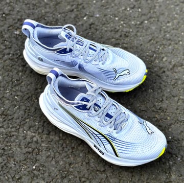 a pair of purple puma nitro running shoes on a tarmac surface a pair of purple puma nitro running shoes on a tarmac surface