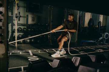 individual training with battle ropes in a gym setting
