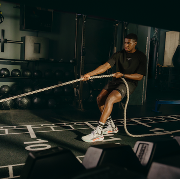 individual training with battle ropes in a gym setting individual training with battle ropes in a gym setting