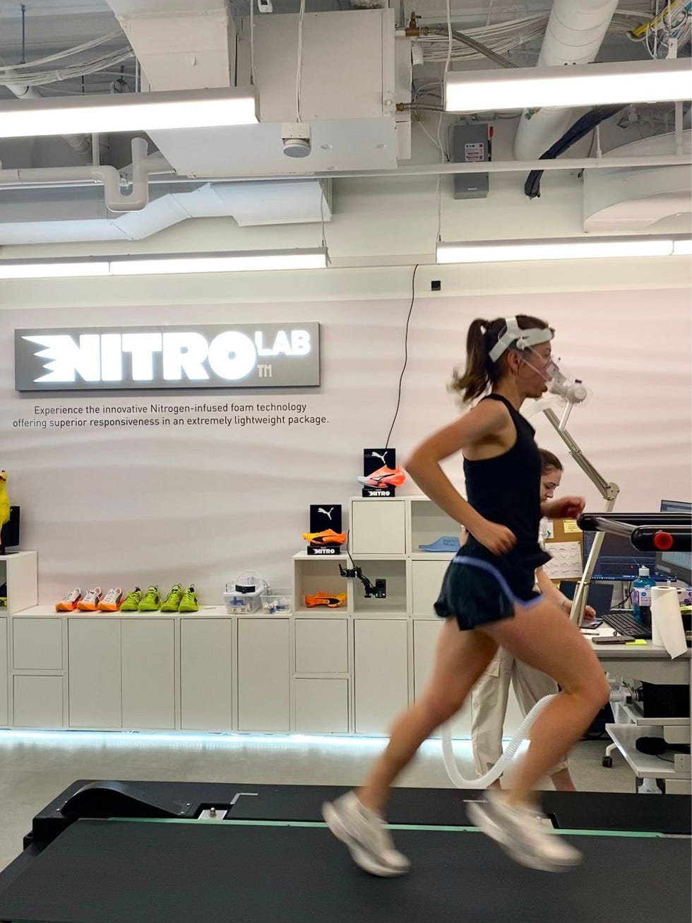 a person running on a treadmill in a modern lab environment