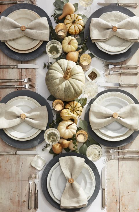 neutral tones place setting with whitewashed pumpkins, dried gourds and diy button napkin rings