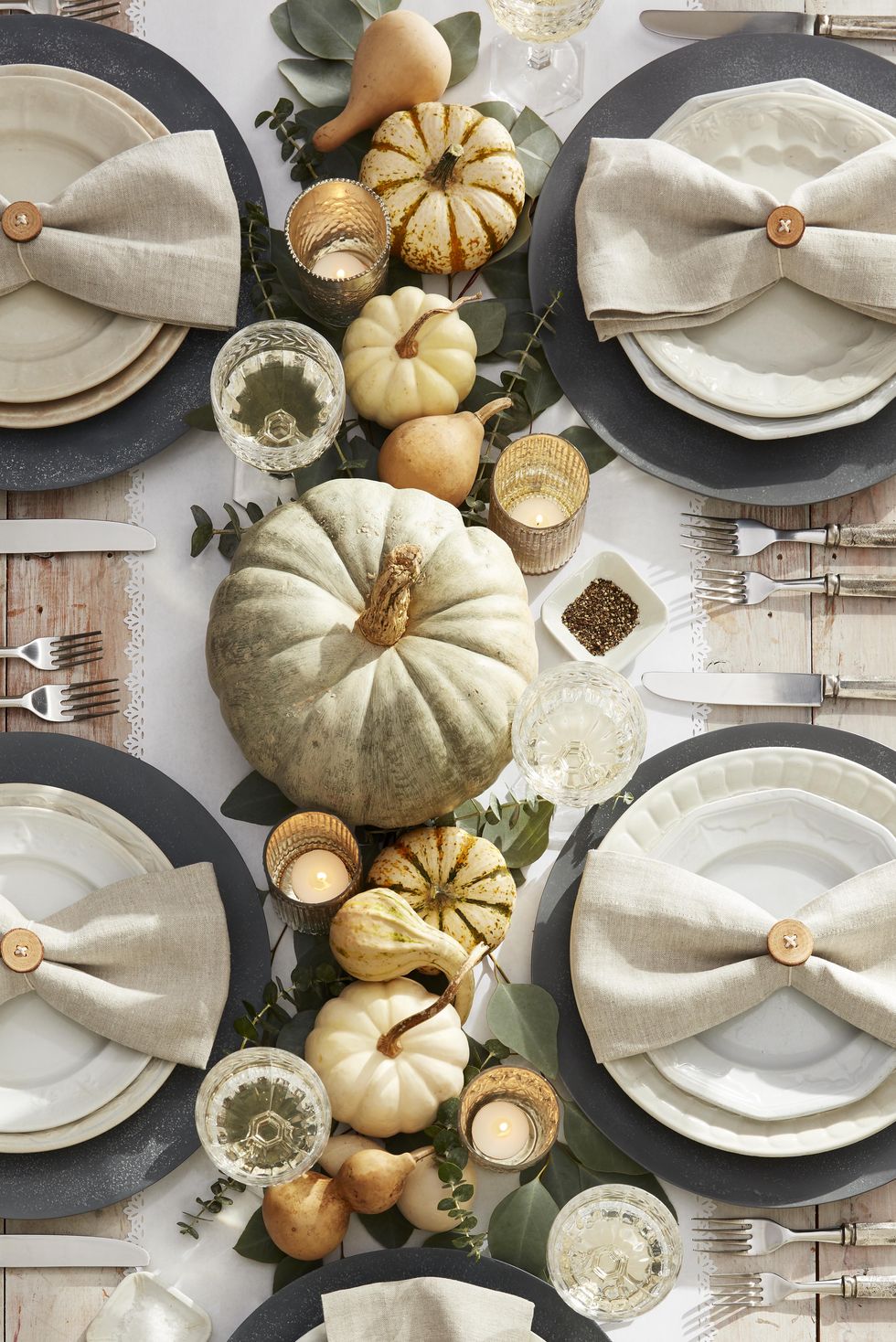 neutral toned pumpkins on thanksgiving table