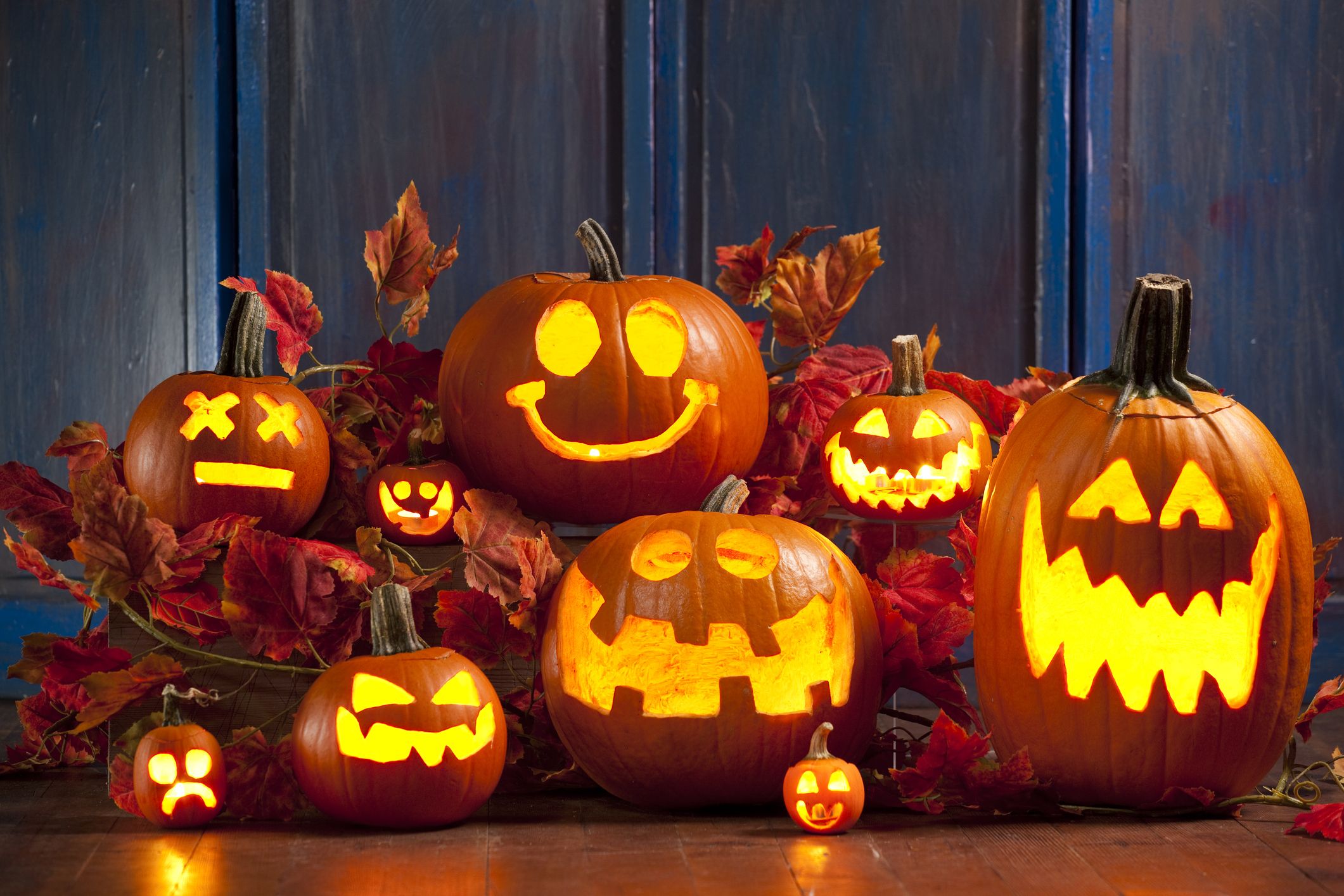 a-carved-pumpkin-with-teeth-and-fangs-on-it-s-face-sitting-on-a-table