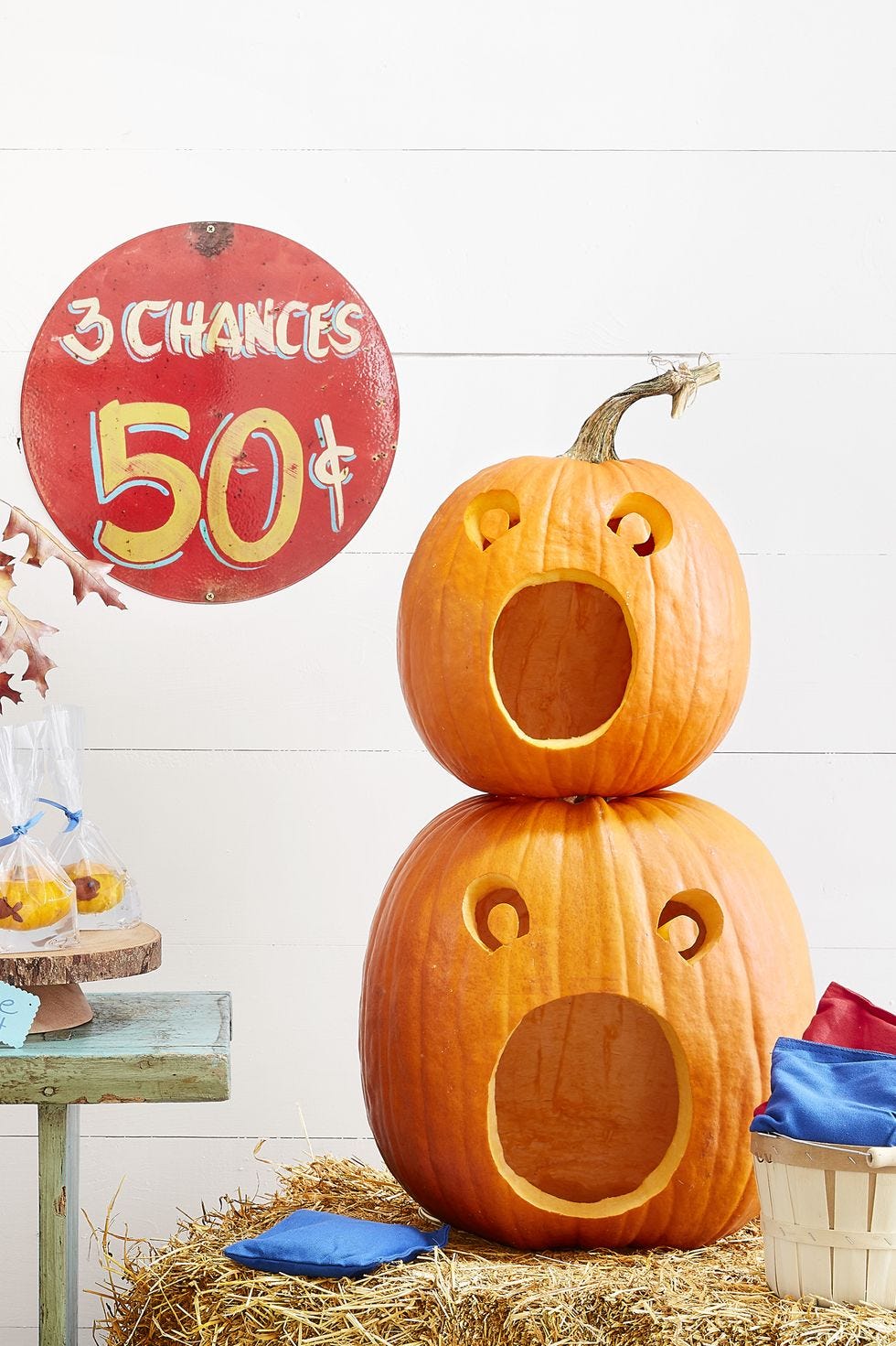 Two stacked pumpkins with open openings carved into them for the Halloween game bean bag