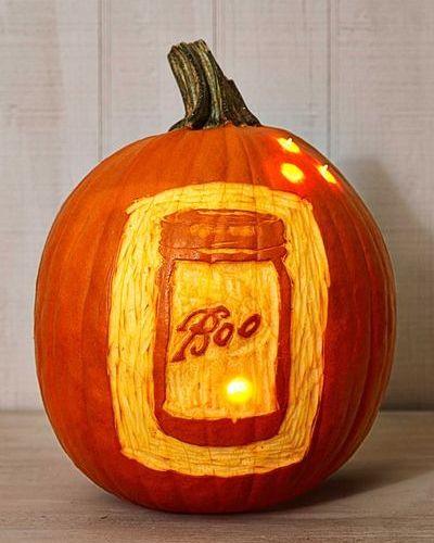 glowing pumpkin with mason jar design carved in relief, with the word boo, instead of bell, in script letters