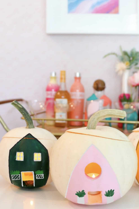 pumpkin carving ideas, white pumpkins with a house painted on the front