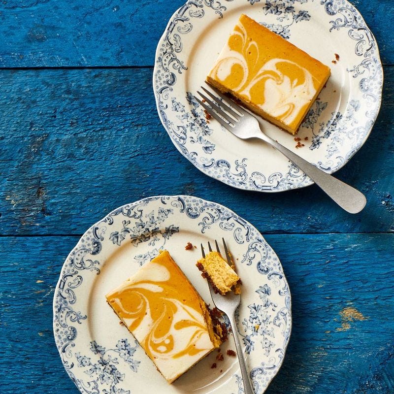 pumpkin cheesecake bars on a white plate