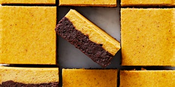 brownies with a chocolate layer and pumpkin cheesecake layer