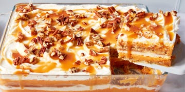 pumpkin cheesecake lasagna topped with pecans and caramel