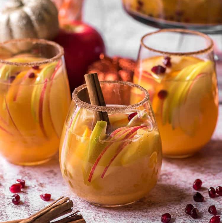 pumpkin party punch with pomegranate seeds and apple slices