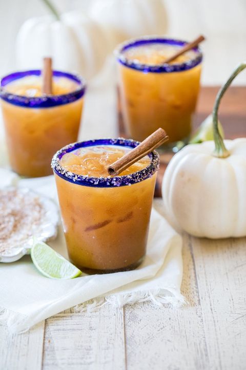pumpkin spice margaritas with lime wedge and white pumpkin