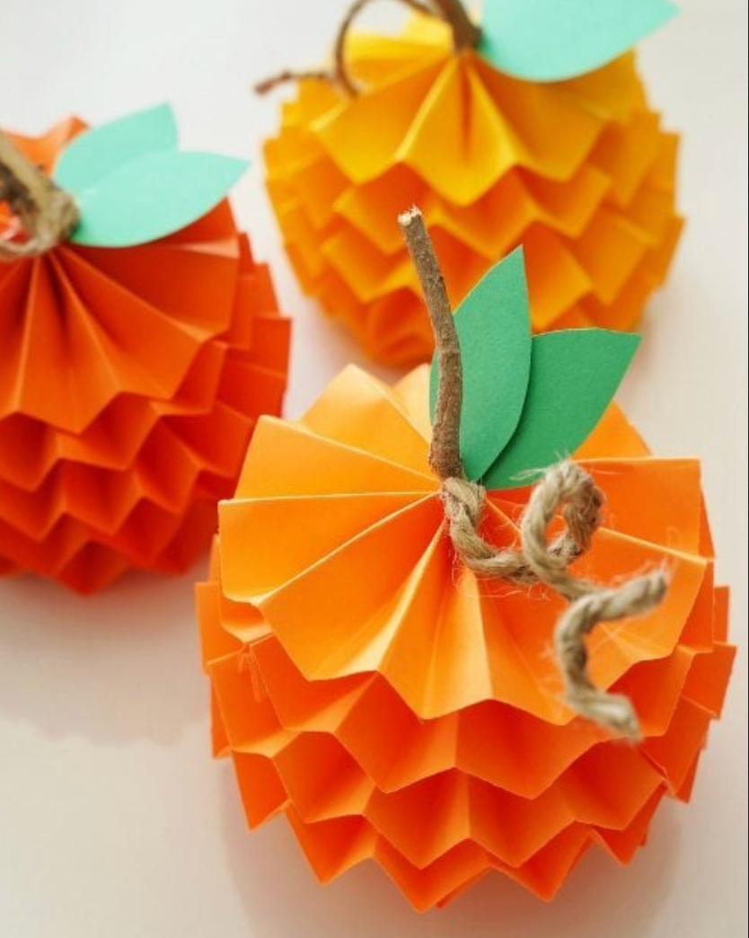 Pumpkins shaped from folded orange paper with a twig stem and twine vine pumpkins shaped from folded orange paper with a twig stem and twine vine