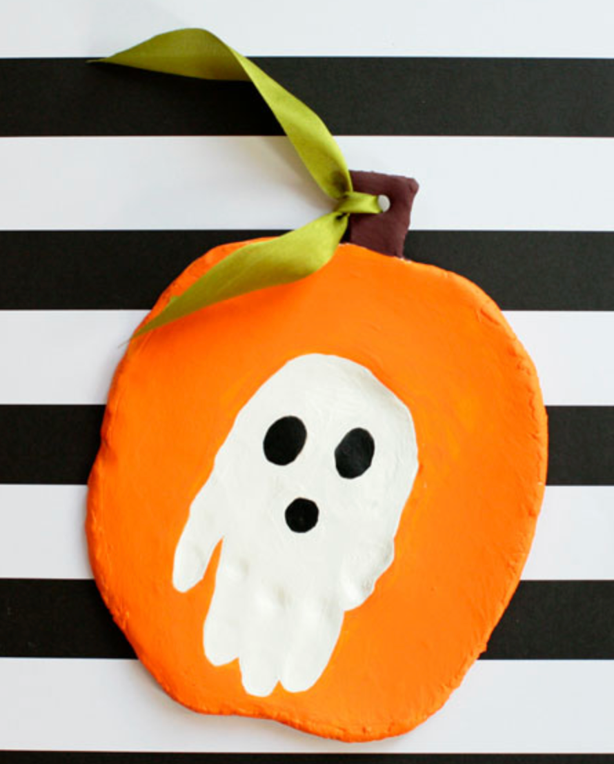 Pumpkin shape made from air dry clay with a childs handprint in the middle pumpkin shape made from air dry clay with a childs handprint in the middle