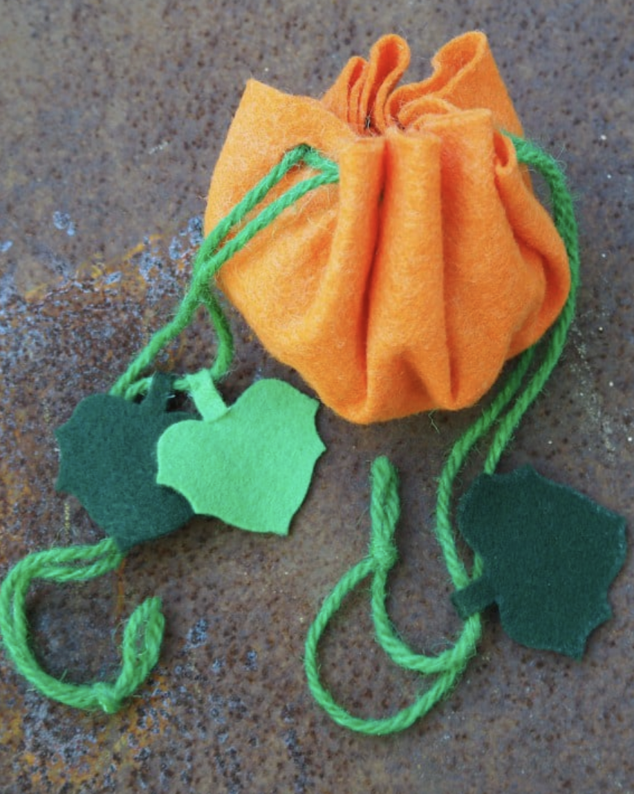 pumpkin shaped treat bag made from orange and greenfelt and string