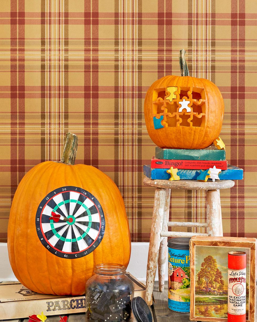 dartboard and jigsaw puzzle pumpkin display pictured with vintage games including dominos, fiddlesticks lincoln logs