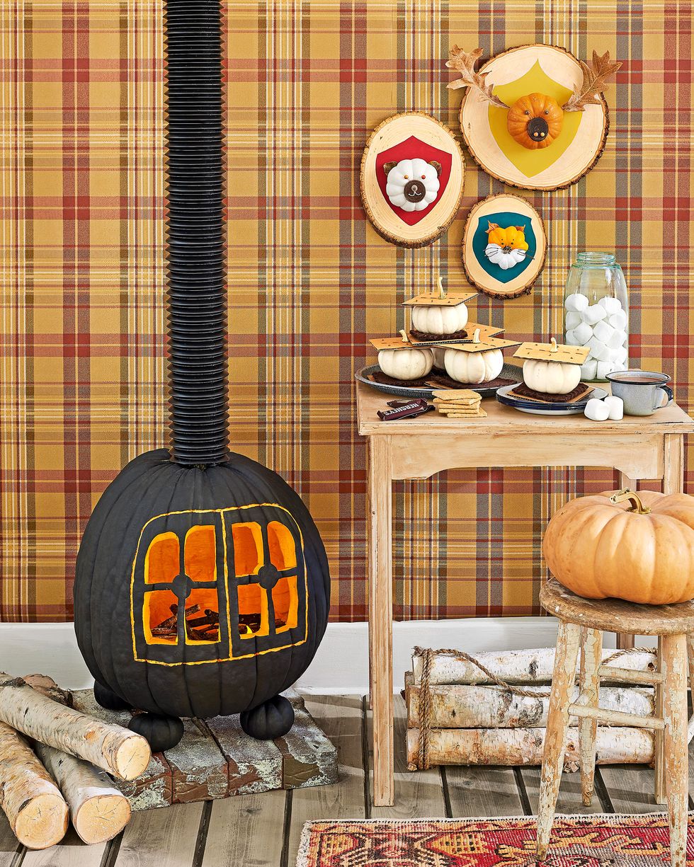 cozy cabin scene with wood burning stove, hunting trophy plaques and smores all made from pumpkins, plaid wallpaper backdrop