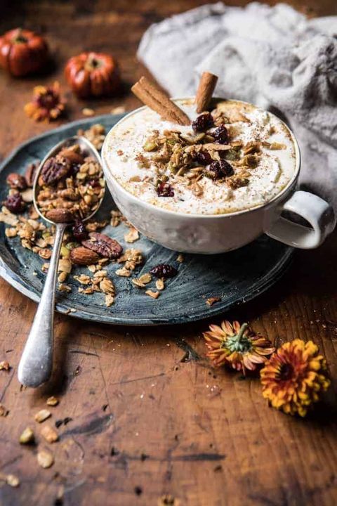 spice oatmeal latte with granola and cinnamon sticks