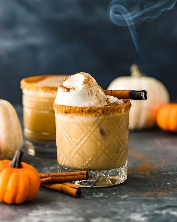 pumpkin spice white russian with cinnamon and pumpkins on side