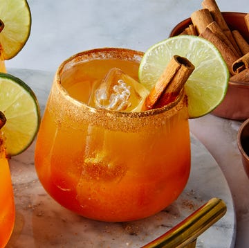 Pumpkin Margaritas pumpkin margaritas garnished with cinnamon stick and lime wheel