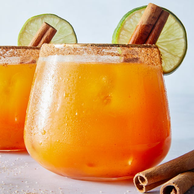 Pumpkin Margaritas pumpkin margaritas garnished with cinnamon stick and lime wheel