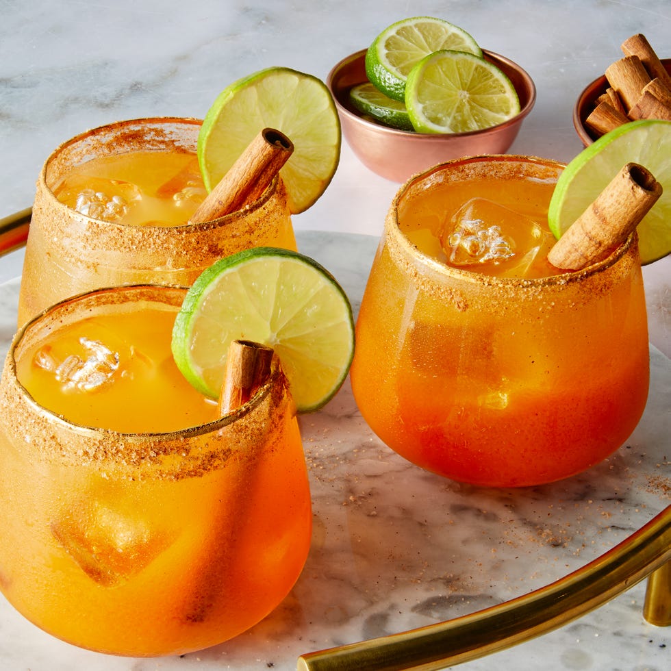 pumpkin margaritas garnished with cinnamon stick and lime wheel