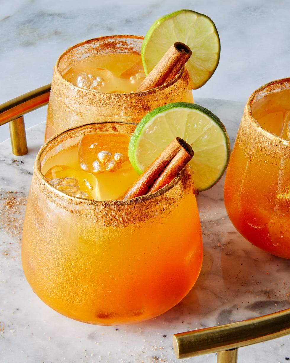 pumpkin margaritas garnished with cinnamon stick and lime wheel