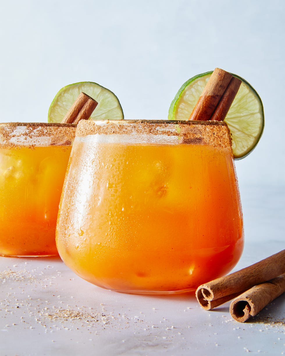 pumpkin margaritas garnished with cinnamon stick and lime wheel