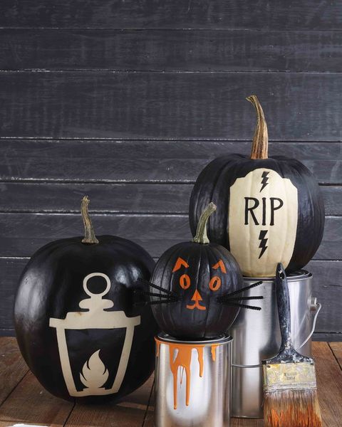 three pumpkins painted black to outline reverse images of lantern, cat, and headstone reading rip in original pumpkin colors