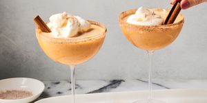 pumpkin pie martini with whipped cream and a cinnamon stick