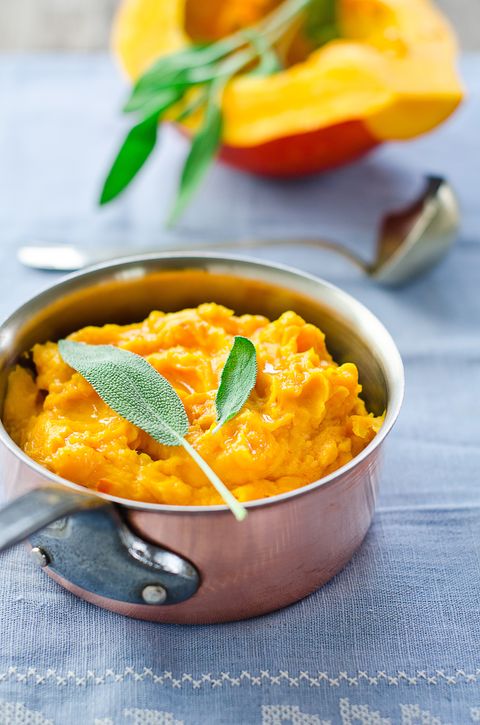 a copper pot of pumpkin puree on a blue tablecloth, a good housekeeping pick for a healthy weight loss food