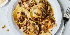 pumpkin ravioli in a brown butter sauce and topped with pumpkin seeds and thyme