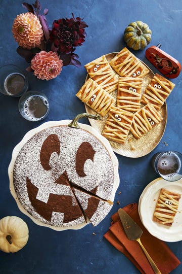 pumpkin mummy hand pies arranged on a gold oval serving plate