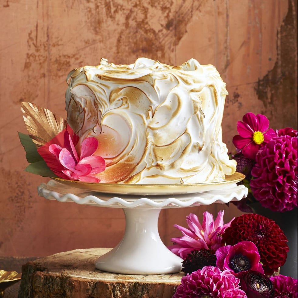 pumpkin spice cake with torched meringue frosting on a white cake stand