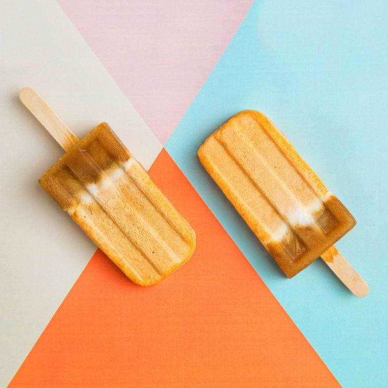 two orange pumpkin spice latte popsicles