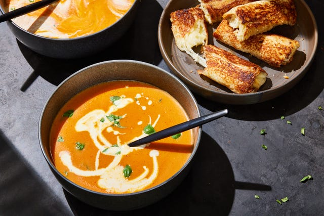 pumpkin tomato soup with cream and herbs served with grilled cheese sticks