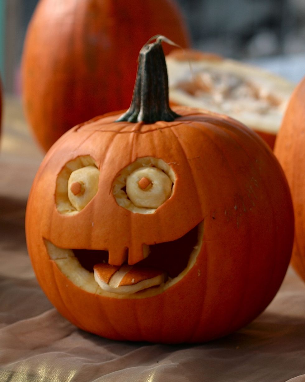 pumpkins decorated with faces with eyes and mouths