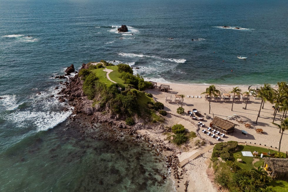 secluded beach landscape with a rocky outcrop and lush greenery secluded beach landscape with a rocky outcrop and lush greenery